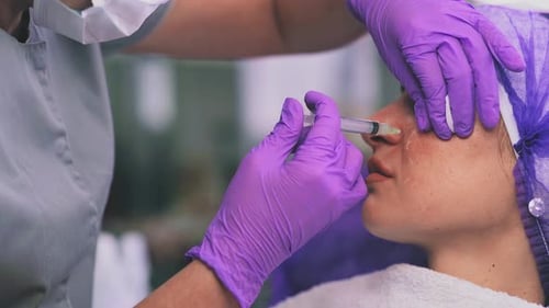 Woman Receiving Cosmetic Injection Treatment at Clinic