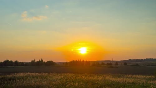 Sunset and tractor working on the field