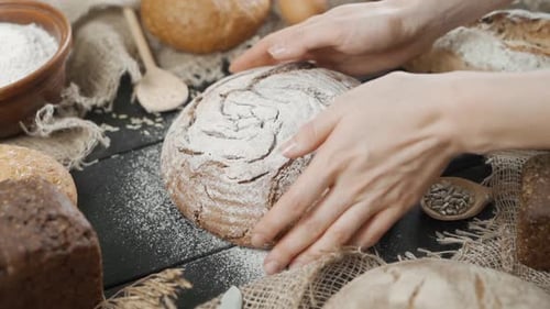 Baker Puts Bread on Table