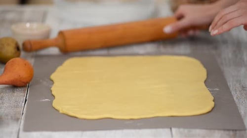 Girl Is Preparing a Cinnabon with Pear Filling. Sweet Homemade Pastry.