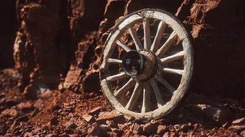 Old Wooden Wagon Wheel in Rocky Desert Landscape