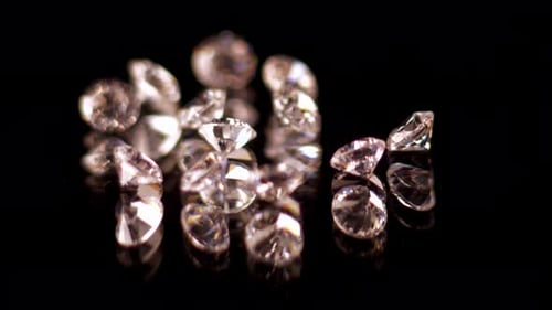 Sparkling Gems on a Reflective Black Surface