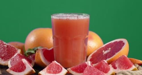 Un vaso de jugo de toronjas maduras gira lentamente.