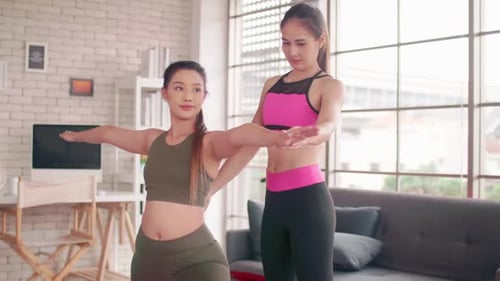 Two Women Exercising Together at Home