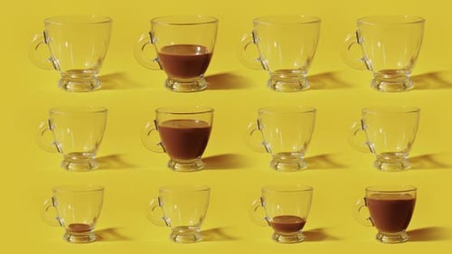 Coffee Fills Mugs on a Yellow Background