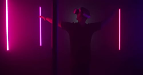 Man Exploring Virtual Reality Near Colorful Illumination