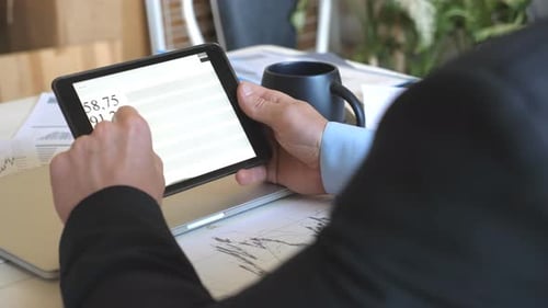 Analyst Reviews Charts on a Tablet
