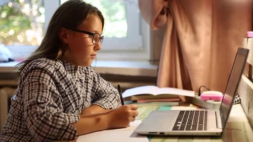 Teen Girl Studying with Laptop and Notebook