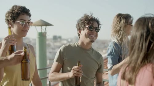 Happy Caucasian Friends Dancing at Rooftop Party on Summer Day