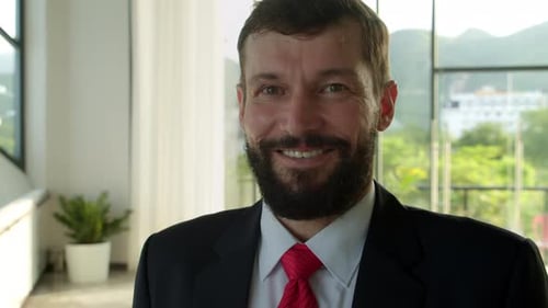 Smiling Businessman Portrait in Office Environment