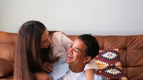 Laughing Couple Posing Together on a Couch