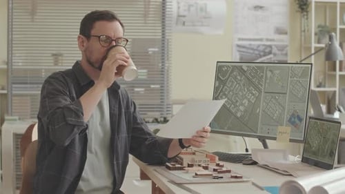 Professional City Planner Examining City Map in Office