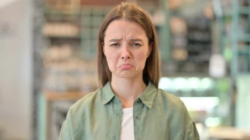 Sad Young Adult Woman With Disappointed Expression