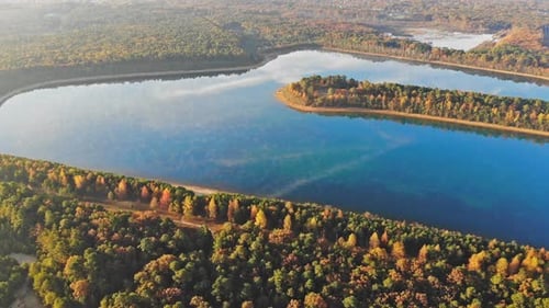Lake Compete with Autumn Color in the Trees for Peaceful Misty Morning