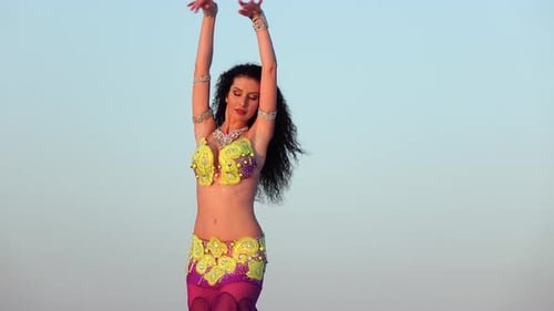 Woman Dances in Desert Outfit with Purple Scarf