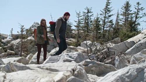 Couple Hiking on Rocky Mountain Terrain on Sunny Day