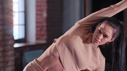 Two Sportive Women Warming Up Before Sports Training in the Gym