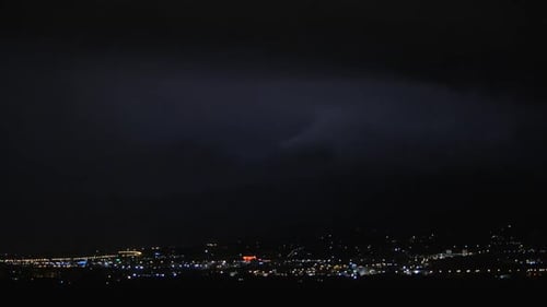 Thunderstorm in Night Illuminated City