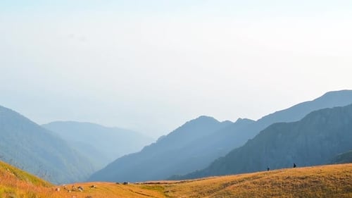 Hikers Exploring Scenic Mountain Landscape on Sunny Day