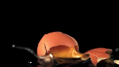 Super Slow Motion the Fresh Egg Falls on the Table and Breaks Down