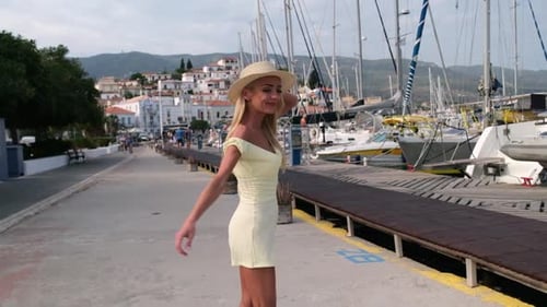 Beautiful Girl Tourist Walking at Marina Sea Port of Poros City Greece
