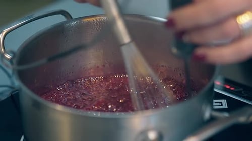 Liquid Simmering in Metal Pot, Stirring with Whisk