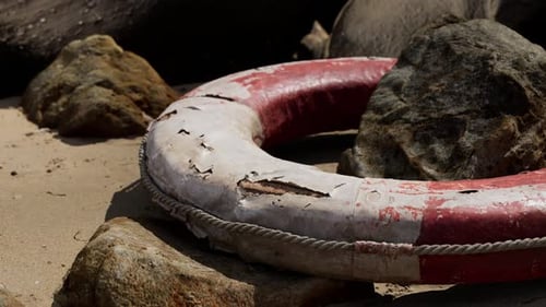 Old Life Buoy on Sandy Beach