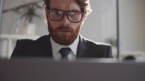 Young Handsome Businessman Working on Laptop in Office