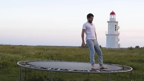 Adult Man Shows Acrobatic Tricks on a Trampoline Slow Motion