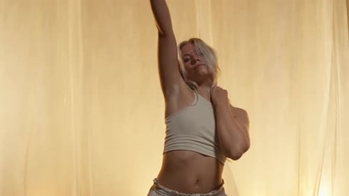 Portrait of a Professional Dancer Performing in Studio in Soft Warm Lighting