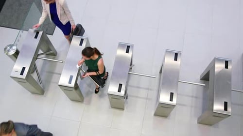 Businesspeople scanning their cards at turnstile gate