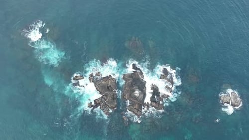 Waves Crash Against Rocks in the Ocean