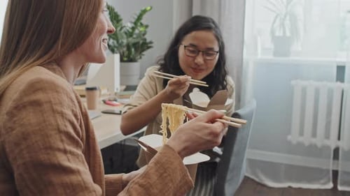 Office Workers Eating Noodles during Lunch Break