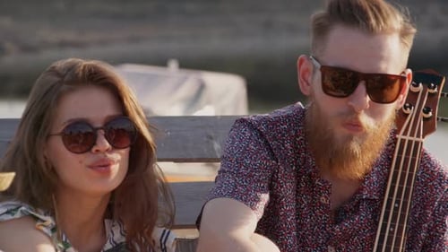 Friends Singing Together Outdoors on the Beach