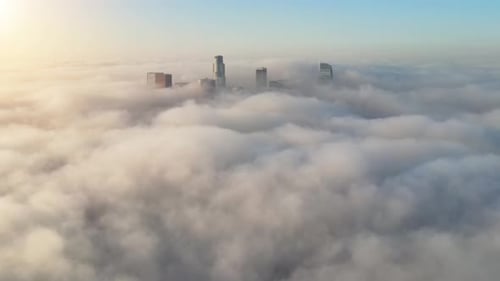 Aerial of the downtown Los Angeles surrounded by clouds