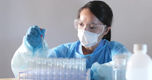 Medical Professional Handles Test Tubes With Pipette