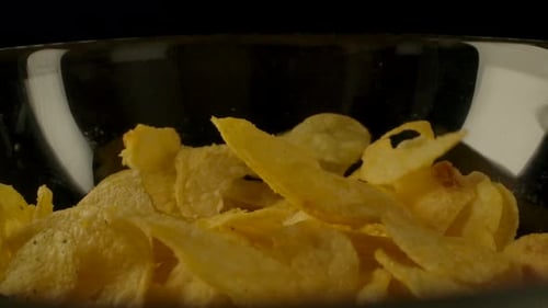 Potato Chips Falling Into Bowl Close Up