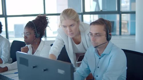 Young Manager Helping Call Center Operators