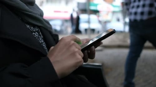 Woman Using Smartphone in Urban Environment