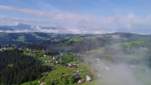 Mountain Village Under Cloudy Sky
