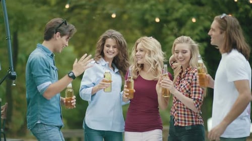 Party. Happy Friends Dancing And Drinking Outdoors