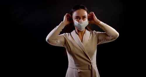 Woman Puts on Face Mask for Protection