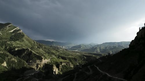 Rocky green mountains on cloudy sky background