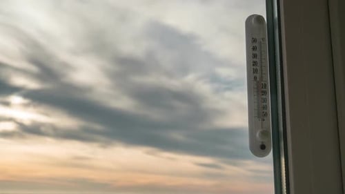 Temperature Thermometer Outside the Window and Changing Weather in Timelapse