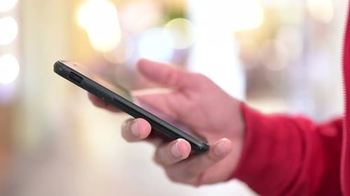 Adult Using Smartphone in Urban Environment