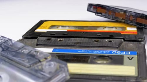 Four Audio Cassettes Rotate on White Background