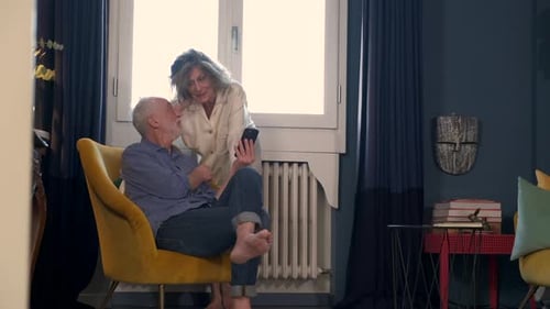 Mature Couple Looking at Smartphone Together at Home