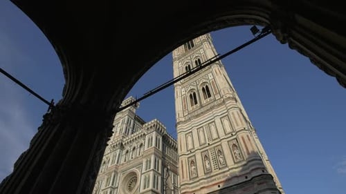 A cathedral facade seen from an arched portico