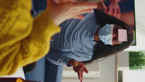 Woman Playing Guessing Game with Friends Indoors