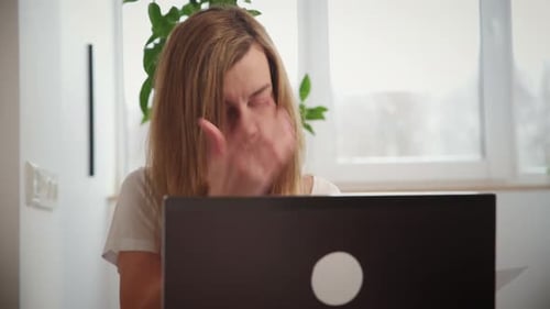 Woman Works at Laptop at Home